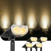 Outdoor floodlights illuminating a garden with plants in the background